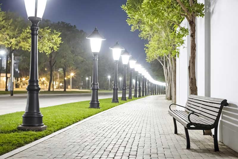 Clean white landscape lighting design showcasing lawn, trees and walkway Mooresville NC